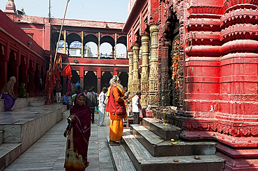 Hindu pilgrim dressed in saffron and red, visiting the Durga Mandir, one of the most famous temples in Varanasi, Uttar Pradesh, India, Asia