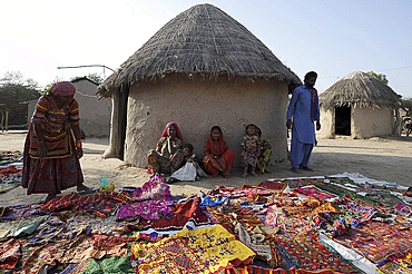 Pathan tribal family in front of traditional mud house (bhunga), showing their colourful tribal embroidery, Jarawali, Kutch, Gujarat, India, Asia