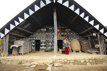 Mother and her child outside their traditionally decorated Naga home, Nagaland, India, Asia