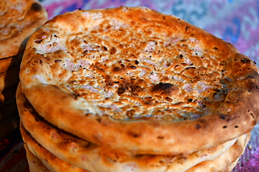 Freshly baked flatbreads for sale in Turfan street night market, Turfan, Xinjiang, China, Asia