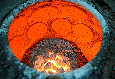 Flatbreads cooking in flatbread oven in Turfan street night market, Turfan, Xinjiang, China, Asia