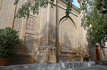 Man outside ornate mosque in city centre, Hotan, Xinjiang, China, Asia