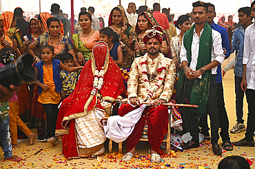 Bride and groom with guests at their wedding as part of tented multiple wedding ceremony, Bhuj, Gujarat, India, Asia