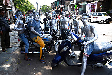 Group of lads who have rebelliously painted themselves silver to celebrate Holi, the Hindu festival of colour, Vadodara, Gujarat, India, Asia