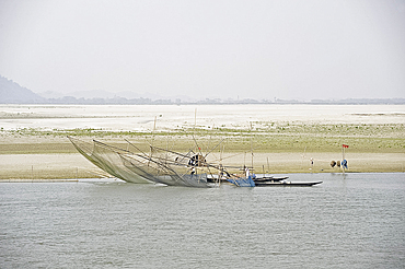 Fishermen working nets on the banks of the Brahmaputra River, near Guwahati, Assam, India, Asia