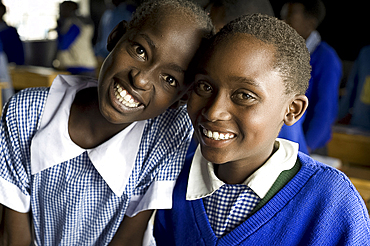 Schoolgirls, two friends, in school uniform and smiling, Karunga Primary School, Rift Valley, Kenya, East Africa, Africa, Africa