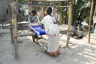 Two women weaving at household loom, Ganeshpahar village, Brahmaputra, Assam, India, Asia