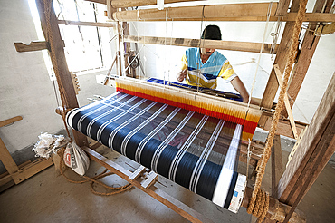 Man weaving coloured silk sari on domestic loom, rural Orissa, India, Asia