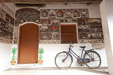 Ornately hand painted wall of artist's house depicting typical Orissan style of work in artists village of Raghurajpur, Orissa, India, Asia