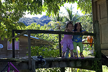 Two girls in a Penan tribal settlement on the banks of the Melinau river, Mulu, Sarawak, Malaysian Borneo, Malaysia, Southeast Asia, Asia