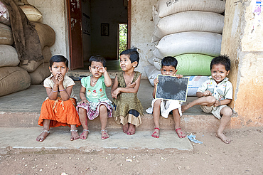 Untouchable village children sitting outside their house in brassmaking Dokhra village, rural Orissa, India, Asia