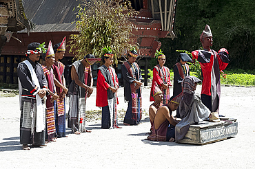 Batak dancers round a large wooden puppet symbolising the king's dead son, inviting villagers to dance, Simanindo, Sumatra, Indonesia, Southeast Asia, Asia