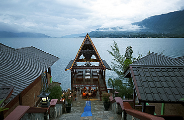 Evening view across Lake Toba from Batak Toba style hotel on Samosir Island, Lake Toba, Sumatra, Indonesia, Southeast Asia, Asia