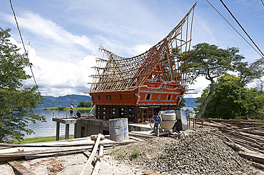 Construction of traditional style Batak house with bamboo scaffolding, beside the volcanic Lake Toba, Samosir Island, Sumatra, Indonesia, Southeast Asia, Asia