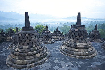 View over early morning monsoon mist lying across countryside, Borobudur Buddhist Temple, UNESCO World Heritage Site, Java, Indonesia, Southeast Asia, Asia