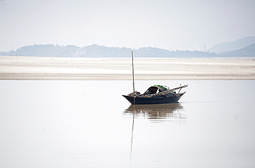 Wooden fishing boat moored on the Brahmaputra River, Assam, India, Asia