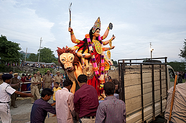 Durga puja deity, made from river mud and decorated, being taken to the Brahmaputra riverbank for Durga puja immersion ceremony, Guwahati, Assam, India, Asia