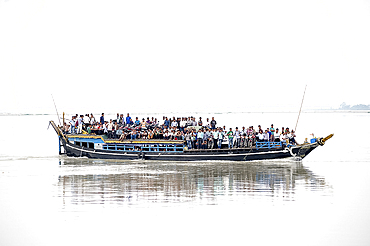 Crowded morning ferryboat carrying office workers and their motorbikes, across the Brahmaputra River, Guwahati, Assam, India, Asia