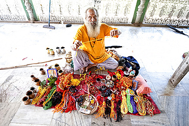 Hindu pundit selling rolimoli (puja wrist threads) in the Sivadol temple, built in 1734, Sivasagar, Assam, India, Asia