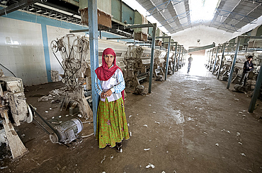 Female factory worker managing machinery in cotton processing factory, Rajkot district, Gujarat, India, Asia