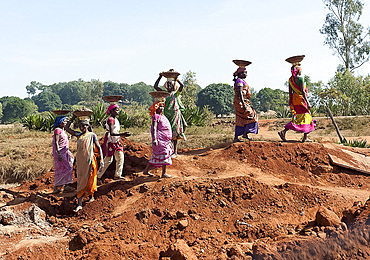 Women, construction workers, in colourful saris carrying soil in baskets on their heads, Koraput district, Orissa (Odisha), India, Asia