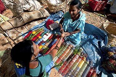 Young woman in turquoise sari selling bangles in Mali weekly tribal market, Guneipada, Koraput district, Orissa (Odisha), India, Asia