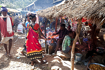 Thatched stalls in busy Mali weekly tribal market, Guneipada, Koraput district, Orissa (Odisha), India, Asia