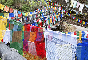 Prayer flags at Mebar Tsho, The Burning Lake, where Pema Lingpa is said to have held a burning butter lamp under the water, Bumthang, Bhutan, Asia