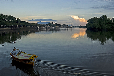 Sampan ferry on the Sarawak River in the centre of Kuching city at sunset, Sarawak, Malaysian Borneo.