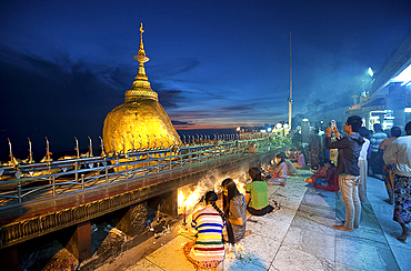 Buddhist pilgrims lighting candles, and visitors at the Golden Rock and Kyaiktiyo Pagoda, Mount Kyaiktiyo, Mon State, Myanmar (Burma), Asia