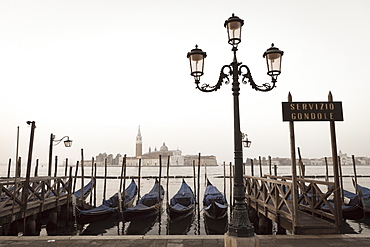 Gondolas moored on the Lagoon, San Giorgio Maggiore beyond, Riva degli Schiavoni, Venice, UNESCO World Heritage Site, Veneto, Italy, Europe