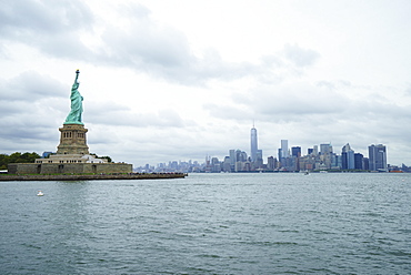 Statue of Liberty with the Lower Manhattan skyline and One World Trade Center beyond, New York City, New York, United States of America, North America