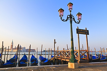 Gondolas moored by Riva degli Schiavoni, looking towards San Giorgio Maggiore, Venice, UNESCO World Heritage Site, Veneto, Italy, Europe