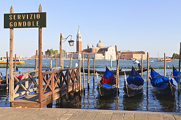 Gondolas moored on the Lagoon, San Giorgio Maggiore beyond, Riva degli Schiavoni, Venice, UNESCO World Heritage Site, Veneto, Italy, Europe