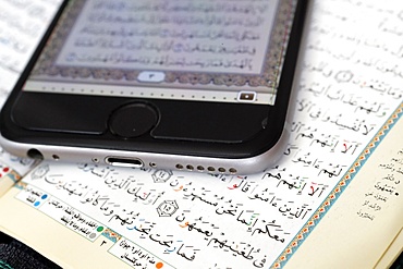 Digital Quran on a smartphone and Holy Quran book, Vietnam, Indochina, Southeast Asia, Asia