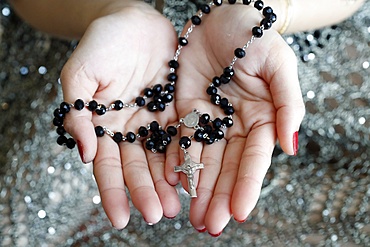 Catholic woman praying rosary beads and crucifix, Vietnam, Indochina, Southeast Asia, Asia