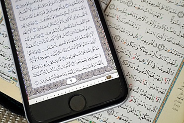 Digital Quran on a smartphone and Holy Quran book, Vietnam, Indochina, Southeast Asia, Asia