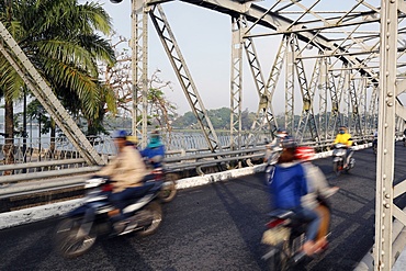 Scooters crossing the famous Trang Tien bridge in morning rush hour traffic, Hue, Vietnam, Indochina, Southeast Asia, Asia