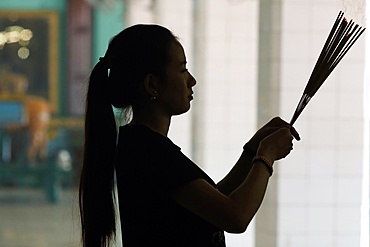 Hindu woman praying with incense sticks, Puja, Sri Thenday Yutthapani Temple, Ho Chi Minh City, Vietnam, Indochina, Southeast Asia, Asia