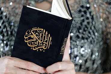 Close-up of woman reading the Noble Quran, Ho Chi Minh City, Vietnam, Indochina, Southeast Asia, Asia