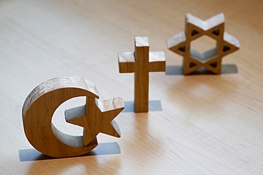 Christianity, Islam, Judaism, the three monotheistic religions in symbols of Jewish Star, Christian Cross and Islamic Crescent, France, Europe