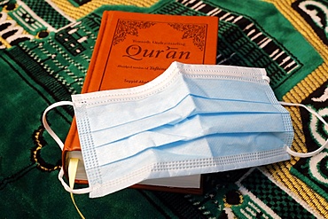 Religion and coronavirus (COVID-19) Quran and disposable surgical mask, Haute-Savoie, France, Europe