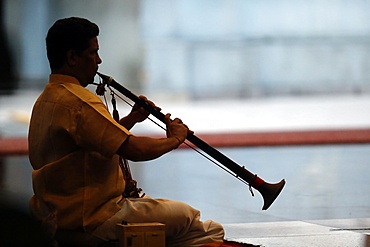 Musician playing a Nadaswaram, a tradional Indian wind instrument, Sri Mahamariamman Hindu Temple, Kuala Lumpur. Malaysia, Southeast Asia, Asia