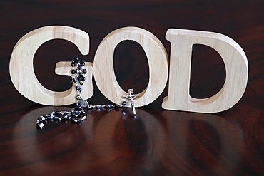 Wooden letters forming the word GOD and Rosary, Christian symbol, Vietnam, Indochina, Southeast Asia, Asia