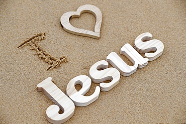 Wooden letters forming the word JESUS with heart on a background of beach sand, I love Jesus, Christian symbol, Vietnam, Indochina, Southeast Asia, Asia