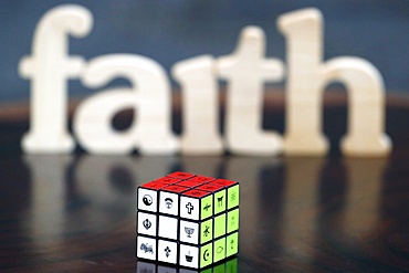 Wooden letters forming the word FAITH and Rubik's cube with religious symbols, Interreligious and interfaith dialog concept, Vietnam, Indochina, Southeast Asia, Asia