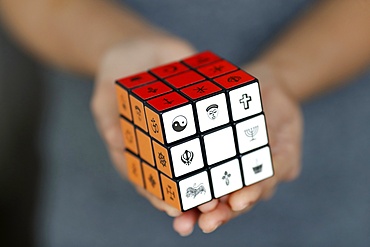 Woman with a Rubik's cube with religious symbols, Interreligious and interfaith dialog concept, Vietnam, Indochina, Southeast Asia, Asia