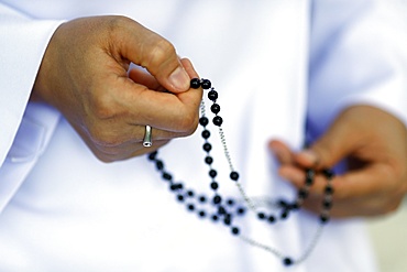 Close-up of hands of Dominican nun praying the rosary beads, Vietnam, Indochina, Southeast Asia, Asia