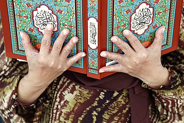 Muslim woman reading the Quran, The National Mosque (Masjid Negara), Kuala Lumpur, Malaysia, Southeast Asia, Asia