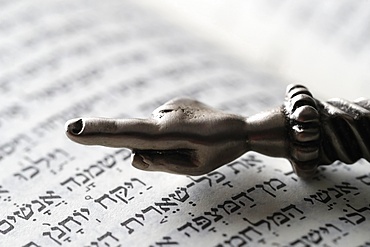 A silver Yad Jewish ritual pointer on a Torah, France, Europe